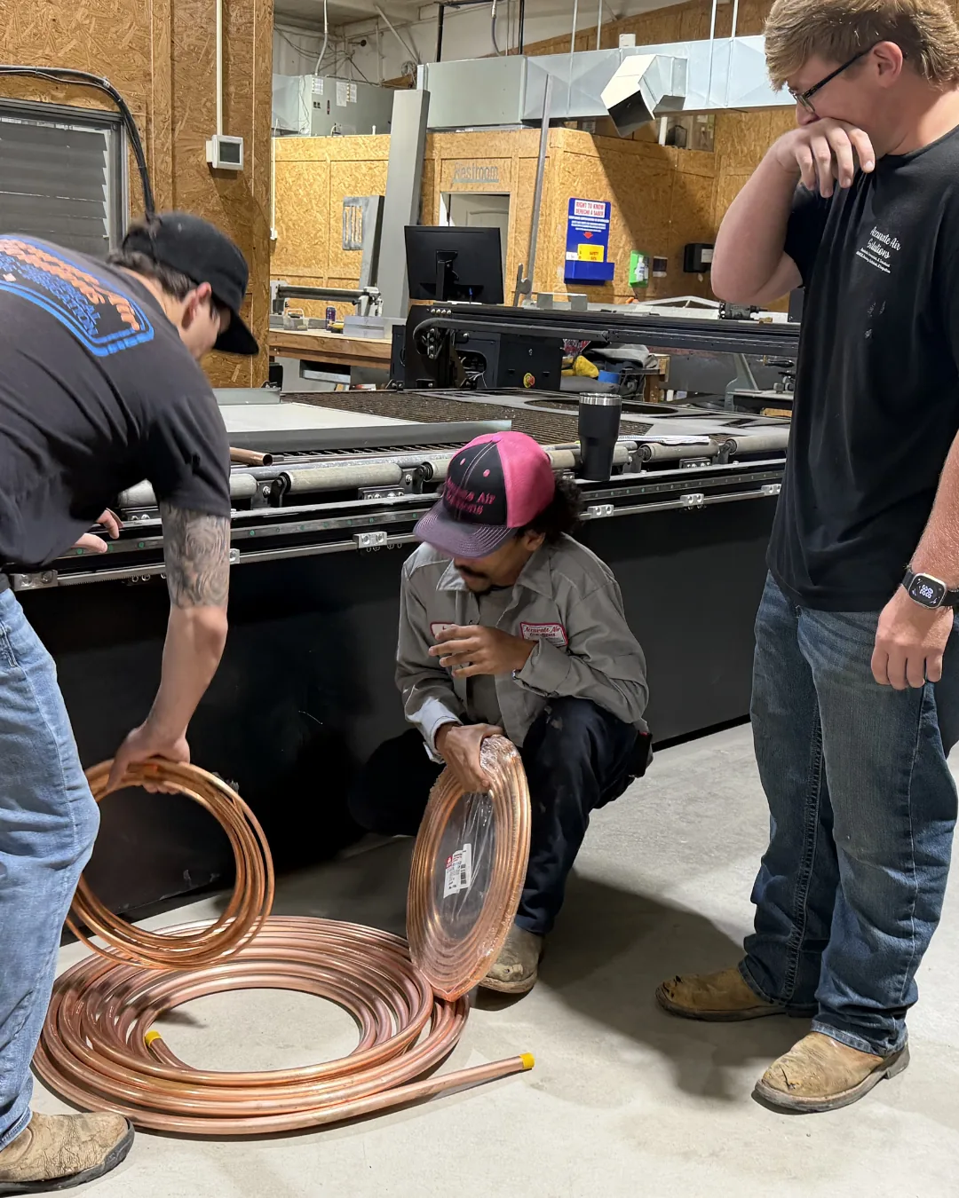 Hawkins crew working with copper line sets in the shop