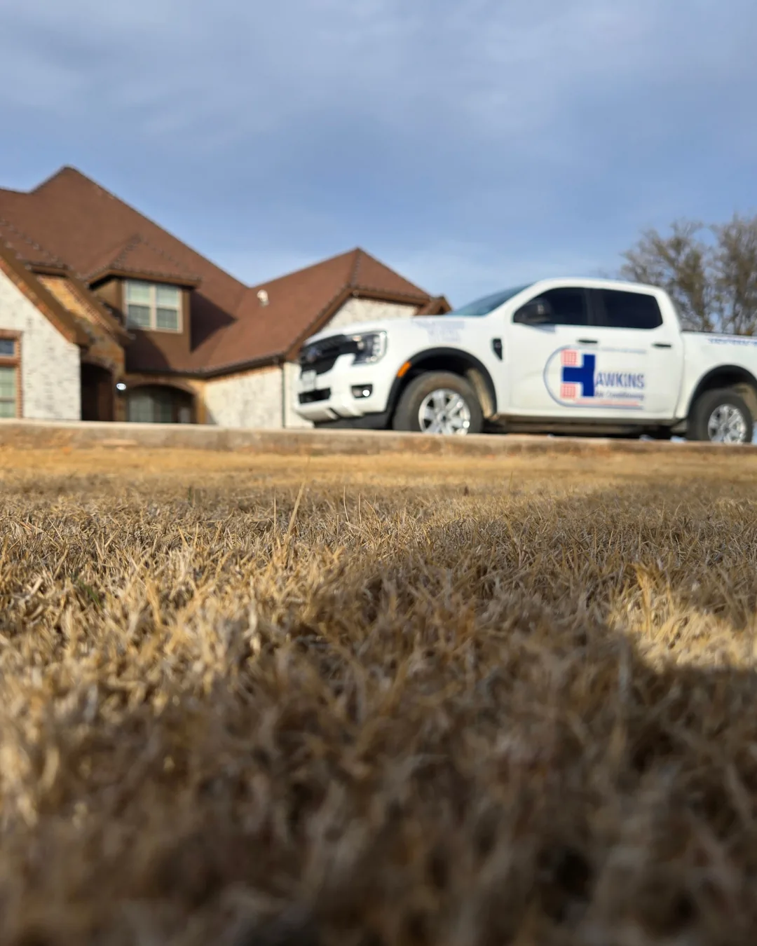 Hawkins Air Conditioning truck parked at a customer home near Winters