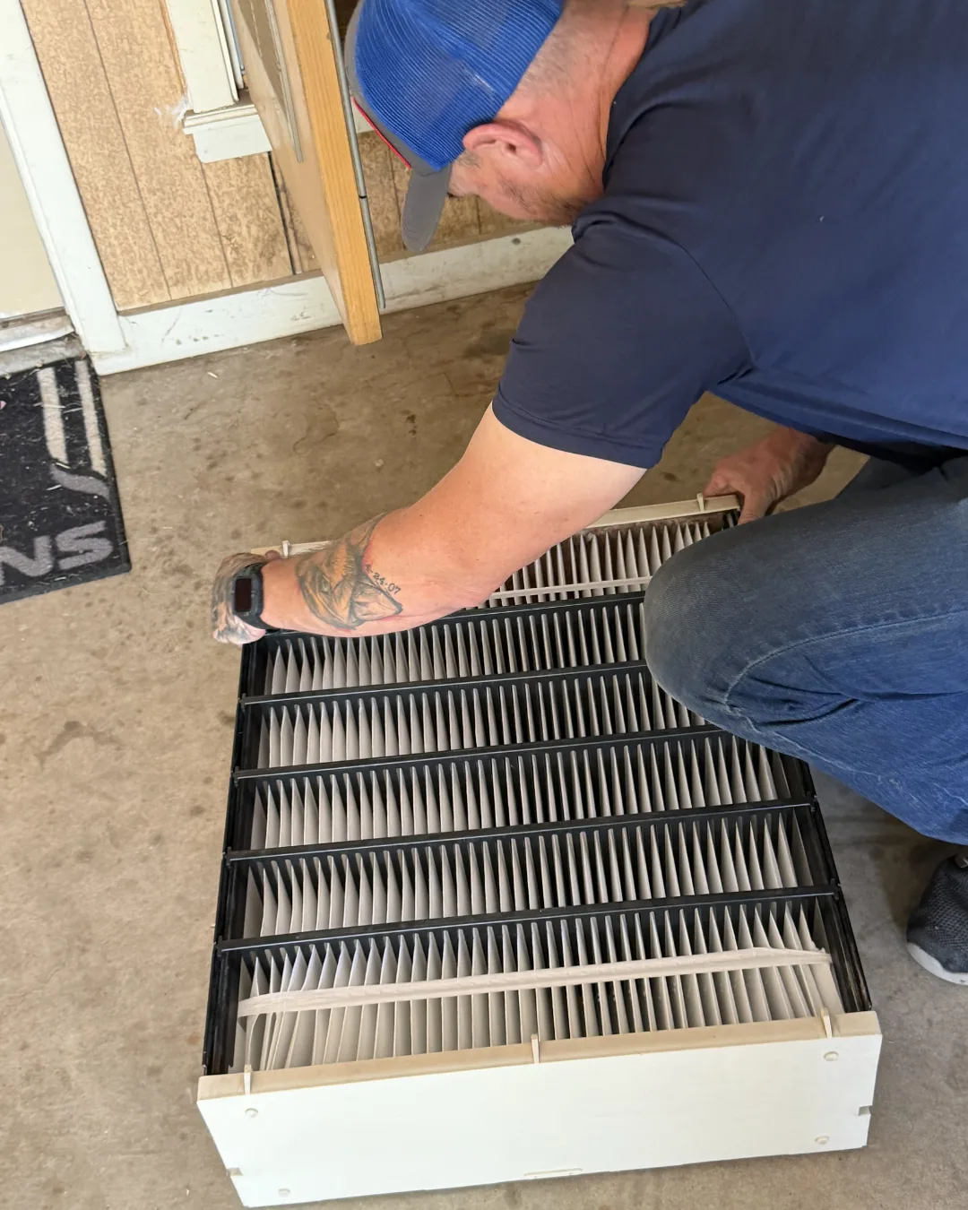 Hawkins technician pulling an evaporator coil during a maintenance check