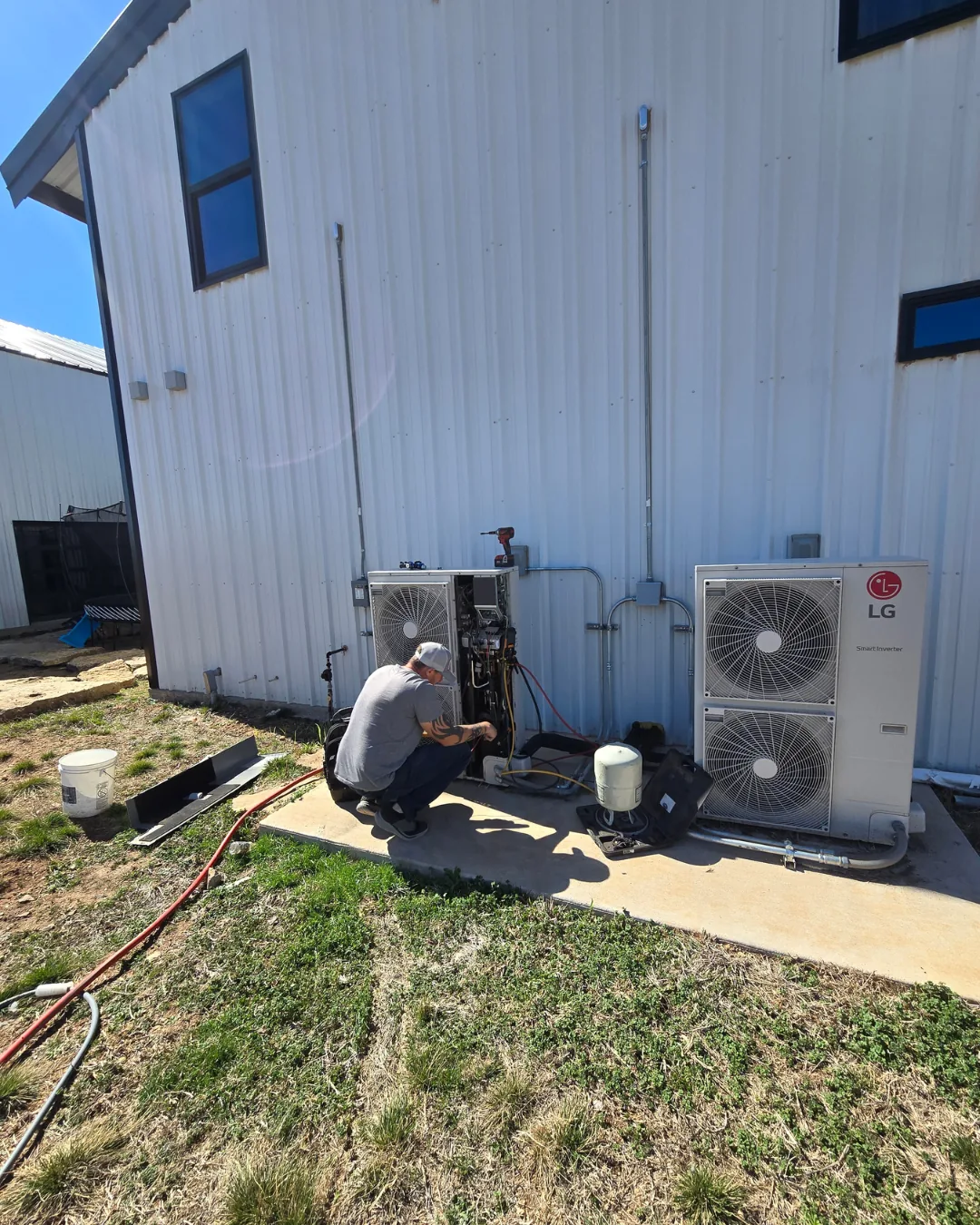 Hawkins technician installing an outdoor AC unit at an Abilene property